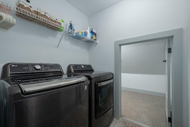 washroom featuring light colored carpet and washing machine and clothes dryer