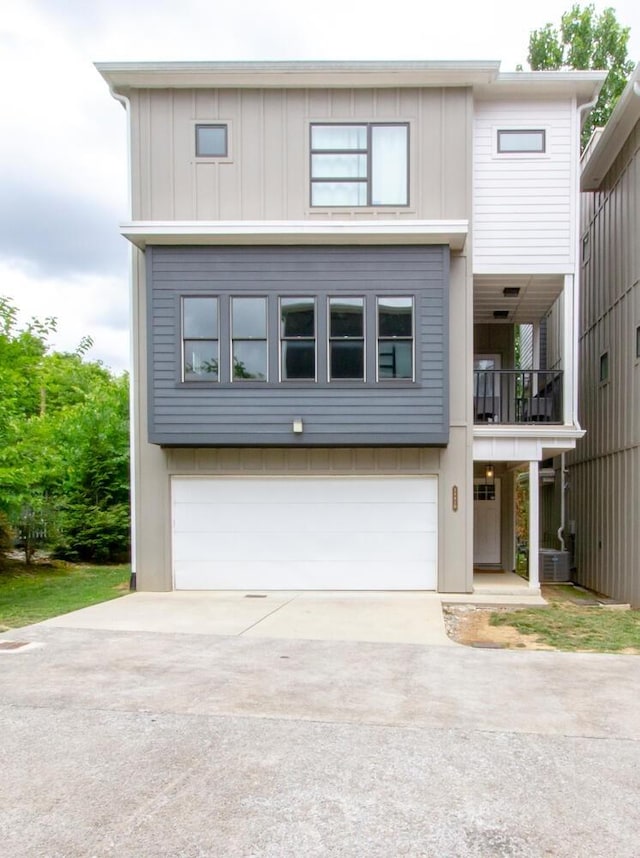 view of front of home with a garage and a balcony