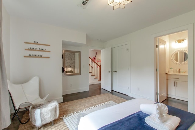 bedroom with ensuite bath and a closet