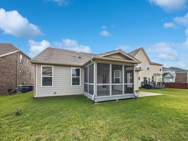 back of property featuring central AC unit, a yard, a patio area, and a sunroom