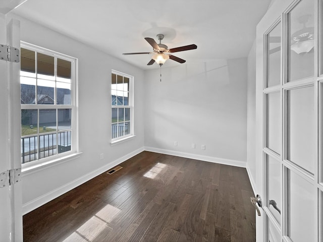 empty room featuring dark hardwood / wood-style floors and ceiling fan