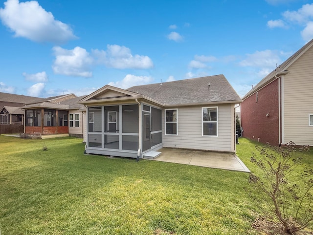 rear view of house with a patio, a sunroom, and a lawn