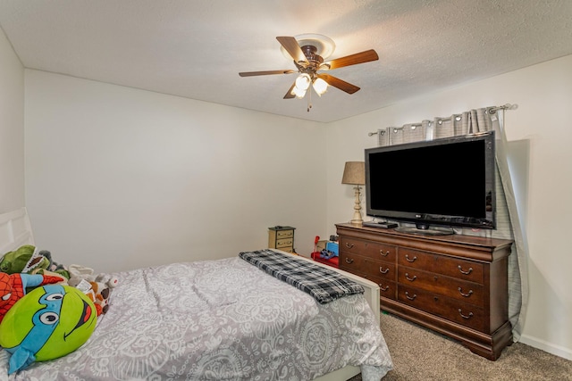 bedroom with ceiling fan, light carpet, and a textured ceiling