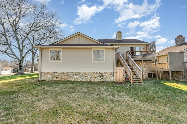 rear view of house featuring a yard and a deck