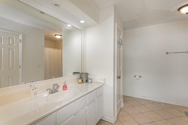 bathroom featuring tile patterned flooring and vanity