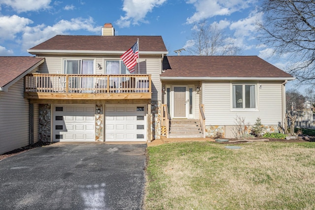 split level home with a garage and a front lawn