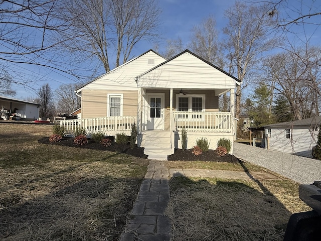 bungalow-style house with a porch and a front yard