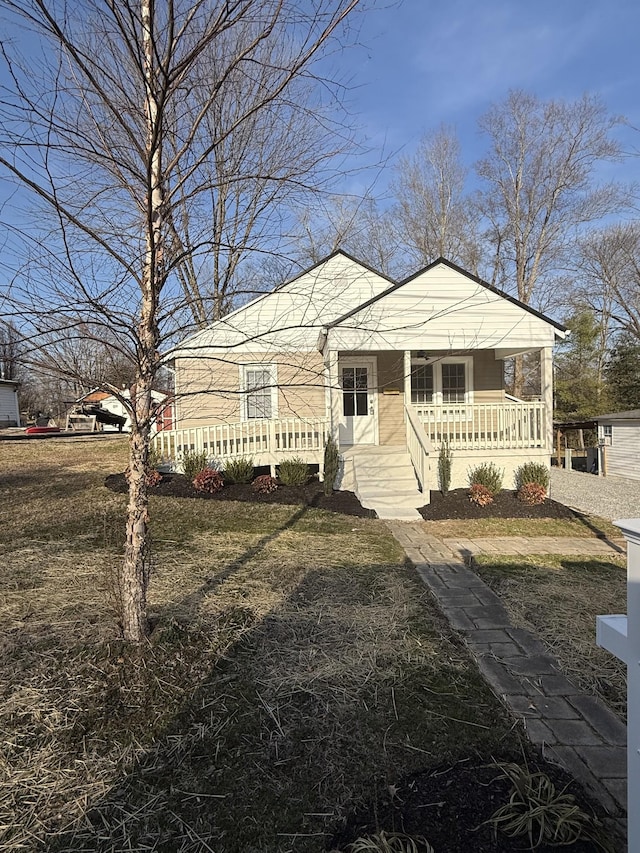 view of front of house with a front yard and covered porch