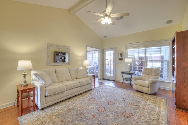 living room featuring hardwood / wood-style floors, beam ceiling, high vaulted ceiling, and ceiling fan