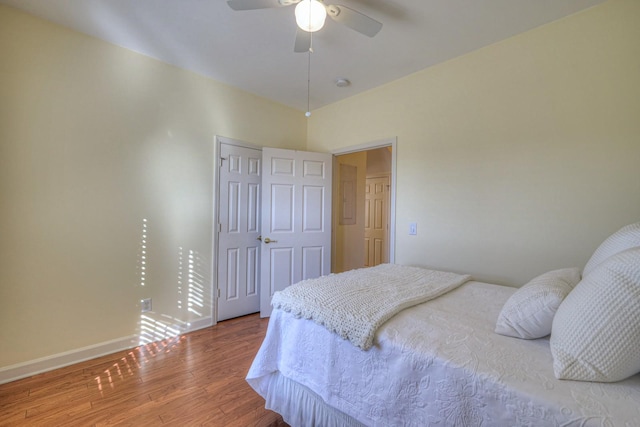 bedroom with hardwood / wood-style floors, ceiling fan, and a closet