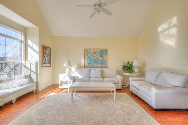 living room featuring wood-type flooring, lofted ceiling, and ceiling fan