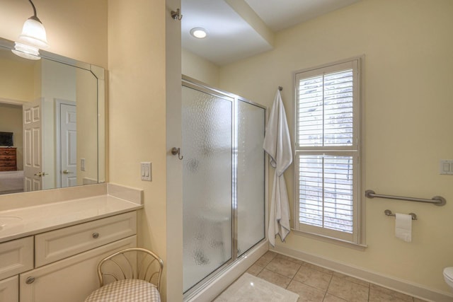 bathroom with vanity, toilet, an enclosed shower, and tile patterned flooring