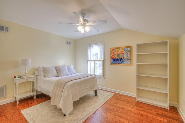 bedroom featuring ceiling fan, lofted ceiling, and wood-type flooring