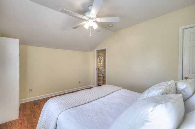 bedroom featuring dark wood-type flooring, vaulted ceiling, and ceiling fan