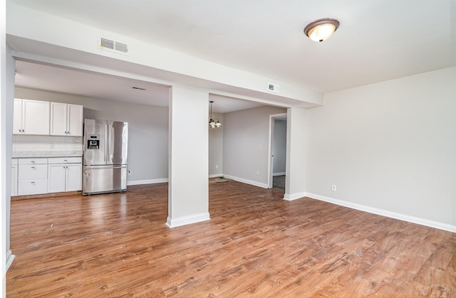 unfurnished living room with hardwood / wood-style flooring