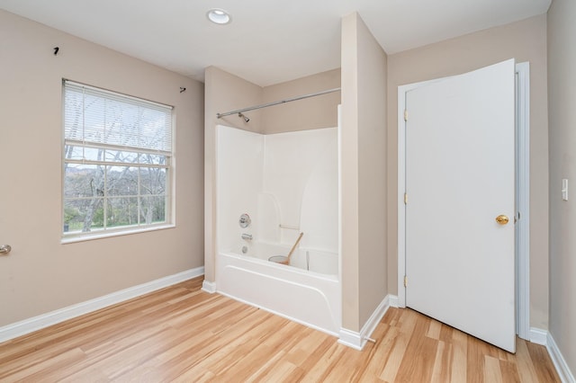 bathroom featuring hardwood / wood-style flooring and shower / tub combination