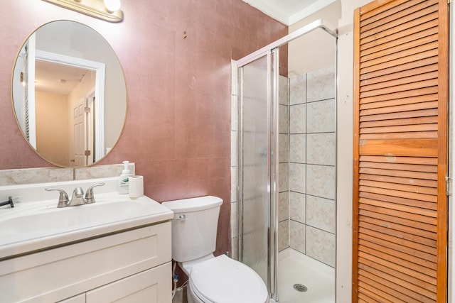 bathroom with walk in shower, vanity, and toilet