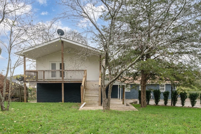 back of house with a deck and a lawn