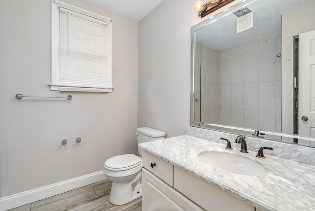 bathroom with vanity, hardwood / wood-style flooring, toilet, and walk in shower