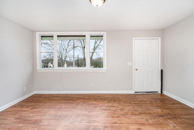 unfurnished room with hardwood / wood-style flooring