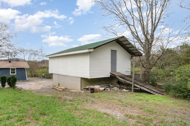 view of side of home featuring a lawn