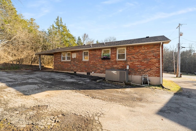 back of property featuring central AC