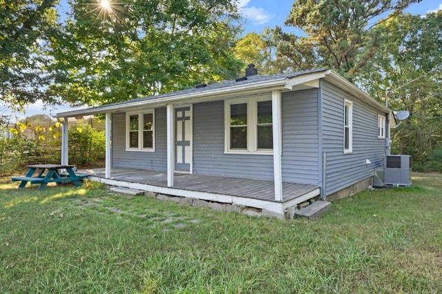 exterior space featuring central AC unit and a front yard