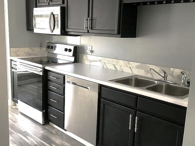 kitchen with wood-type flooring, appliances with stainless steel finishes, and sink