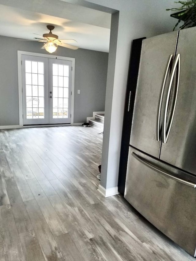 kitchen with stainless steel refrigerator, ceiling fan, light hardwood / wood-style flooring, and french doors