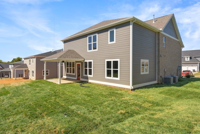 rear view of house with central AC unit, a yard, and a patio area