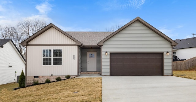 view of front of property featuring a garage and a front yard