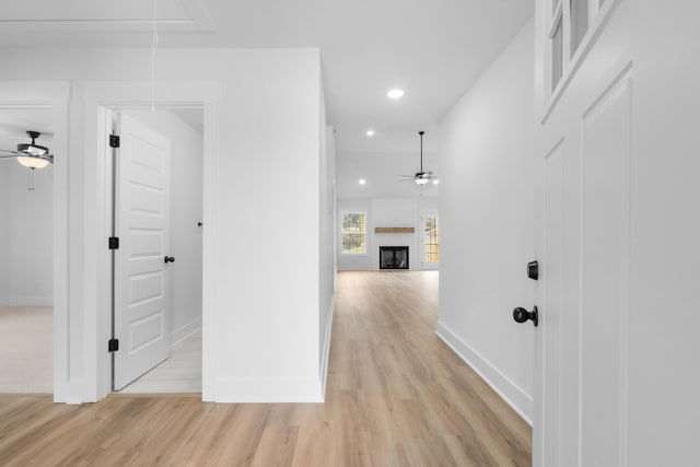 corridor with light hardwood / wood-style flooring