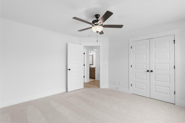 unfurnished bedroom with light carpet, a closet, and ceiling fan