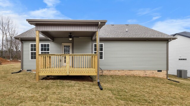 back of property with a wooden deck, central AC unit, ceiling fan, and a lawn