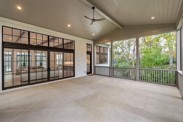 unfurnished sunroom featuring wood ceiling, ceiling fan, and vaulted ceiling with beams