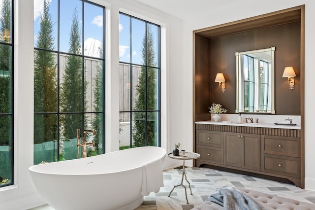 bathroom with vanity and a tub