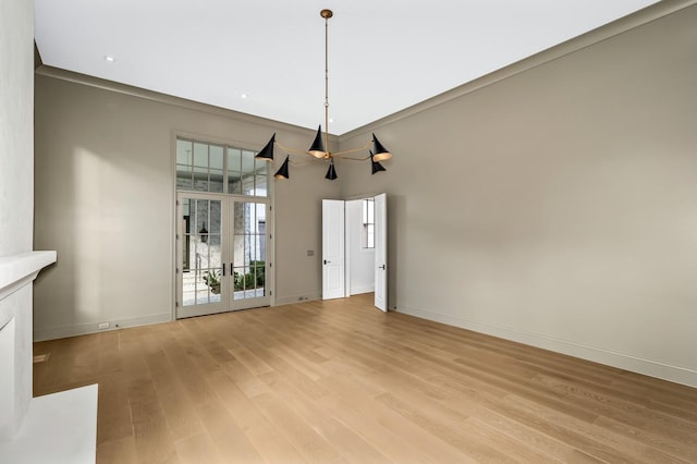 unfurnished dining area featuring light wood-type flooring and french doors