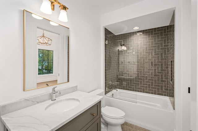 full bathroom featuring vanity, toilet, and tiled shower / bath