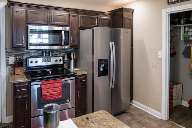 kitchen with stainless steel appliances, dark brown cabinets, and decorative backsplash