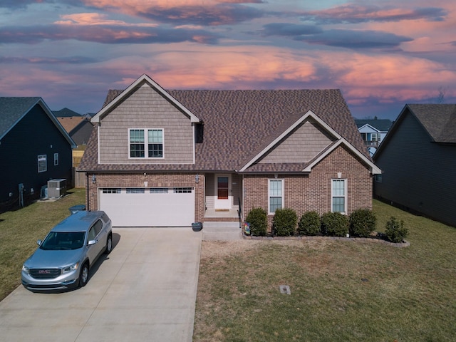 craftsman-style house with a yard, a garage, and central AC unit