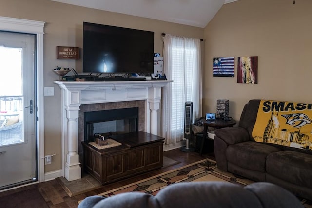 living room with lofted ceiling and a fireplace