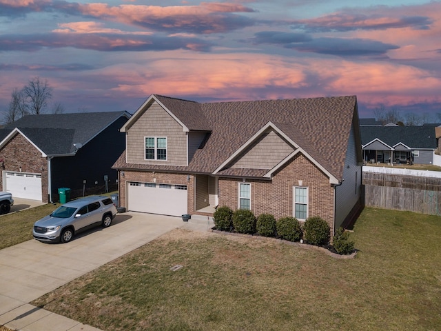 view of front of property with a garage and a lawn