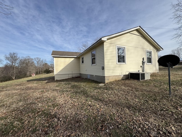 view of side of home featuring central AC