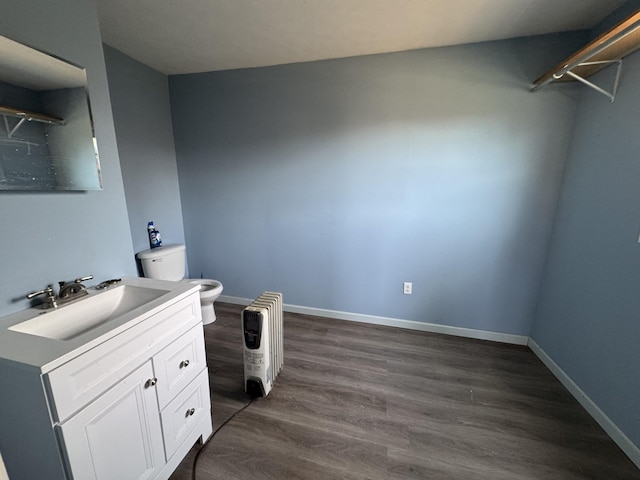 bathroom with vanity, hardwood / wood-style floors, and toilet