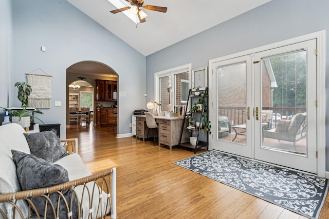 interior space featuring hardwood / wood-style floors, high vaulted ceiling, french doors, and ceiling fan