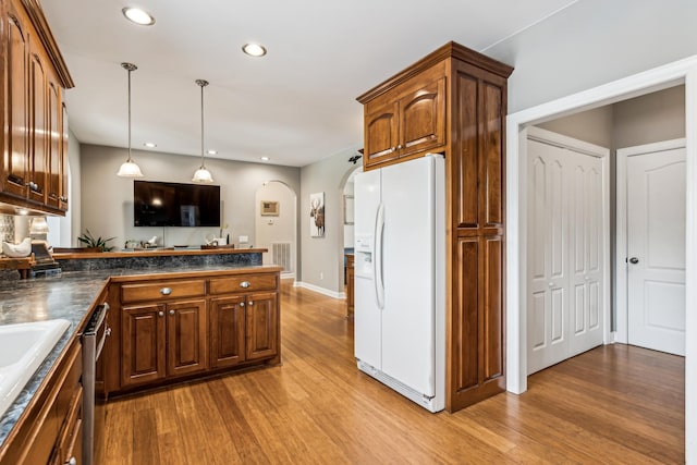 kitchen with light hardwood / wood-style flooring, sink, white refrigerator with ice dispenser, and dishwasher