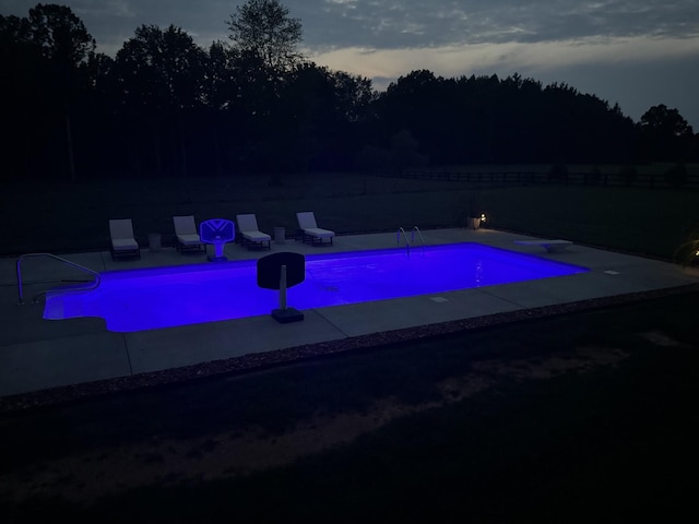 view of pool at dusk