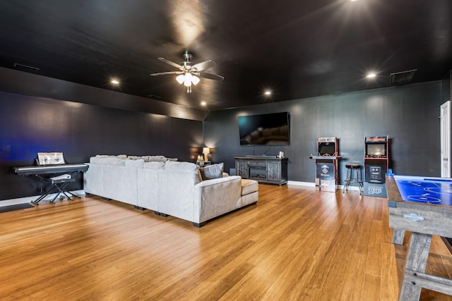 living room with ceiling fan and light hardwood / wood-style floors