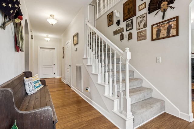 staircase with wood-type flooring