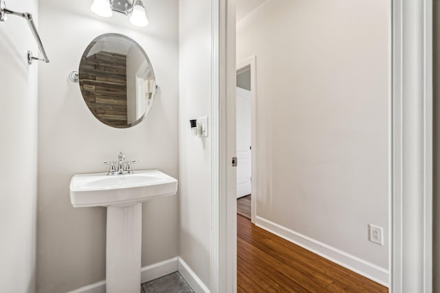 bathroom with hardwood / wood-style flooring and sink